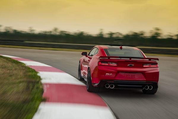 Rear view of 2023 Chevrolet Camaro ZL1 cornering on a track