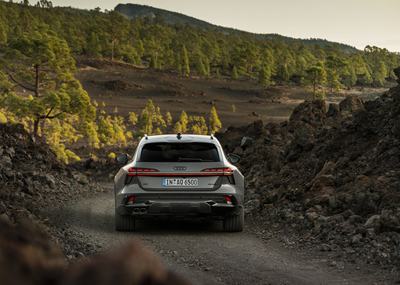 Rear view of the Audi A6 allroad (pearlgrey) on a narrow gravel track in volcanic terrain.