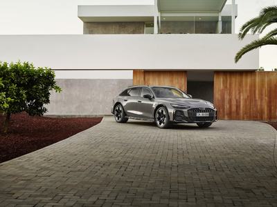 Audi A6 allroad (pearl grey) front view in modern architecture (static shot)