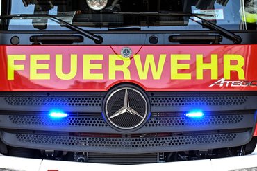 PRODUCTION - 19 July 2022, Baden-Wuerttemberg, Karlsruhe: At the Competence Center Aerial Rescue of the fire equipment manufacturer Rosenbauer, two blue lights shine on a fire truck under the lettering "Feuerwehr". The Austrian company Rosenbauer is one of the world's largest manufacturers of fire fighting vehicles. Photo: Uli Deck/dpa (Photo by Uli Deck/picture alliance via Getty Images)