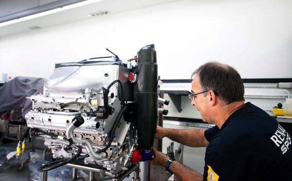 A Renault Sport mechanic working on a V8 Formula One engine inside the Renault paddock based Renault Technical truck at the 2012 British Grand Prix, Silverstone, United Kingdom, on the 5th July 2012. (Photo by Darren Heath/Getty Images)
