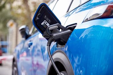 EV car on a public charging station outdoors.