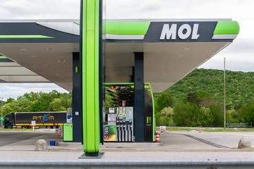 Kozina, Slovenia- 25.04.2025- Modern MOL gas station with fuel pumps on highway and forest background