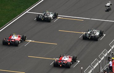 SHANGHAI, CHINA - MARCH 15:The Mercedes-AMG Petronas Formula One Team cars of Kimi Antonelli (P1) and George Russell (P2) sit ahead of the Scuderia Ferrari HP cars of Lewis Hamilton (P3) and Charles Leclerc (P4) on the starting grid in the final moments before the 2026 Chinese Grand Prix, at the Shanghai International Circuit, in Shanghai, China, on March 15, 2026. (Photo by Artur Widak/NurPhoto via Getty Images)