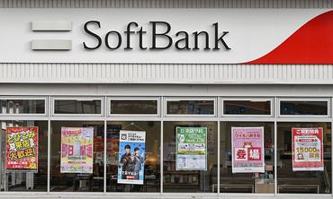 KUDAMATSU, JAPAN - APRIL 14:  The storefront of a SoftBank retail branch, showcasing current mobile and internet service promotions, is pictured in Kudamatsu, Yamaguchi Prefecture, Japan, on April 14, 2026. As a leading telecommunications company, SoftBank offers various consumer services including SoftBank Air home internet and Y!mobile family discount plans, frequently advertised through colorful window posters. (Photo by STR/NurPhoto via Getty Images)