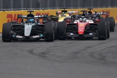 MIAMI, FLORIDA - MAY 03: George Russell of Great Britain driving the (63) Mercedes AMG Petronas F1 Team W17 and Charles Leclerc of Monaco driving the (16) Scuderia Ferrari SF-26 battle for track position and make contact during the F1 Grand Prix of Miami at Miami International Autodrome on May 03, 2026 in Miami, Florida. (Photo by Andy Hone/LAT Images)