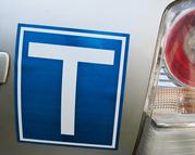 Close-up of a car’s rear with T symbol, representing beginner drivers, learning, growth, and responsibility on the road.
