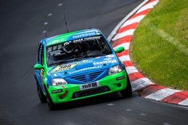 14 May 2026, Rhineland-Palatinate, Nürburg: The Dacia Logan with starting number 300 from the Ollis Garage Racing team with drivers Oliver Kriese, Christian Geilfus, Robert Neumann and Alexander Becker drives on the Nordschleife of the Nürburgring during Qualifying 1. Photo: Silas Stein/dpa (Photo by Silas Stein/picture alliance via Getty Images)