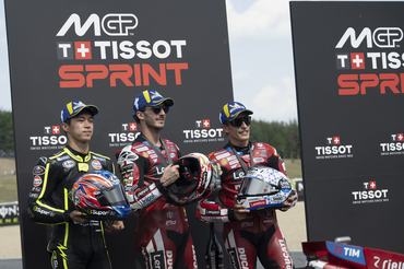 BRNO, CZECH REPUBLIC - JUNE 20: (L-R) Ai Ogura of Japan and Trackhouse MotoGP Team,  Francesco Bagnaia of Italy and Ducati Lenovo Team and Marc Marquez of Spain and  Ducati Lenovo Team celebrate on the podium on track at the end of the MotoGP™ Tissot Sprint race during the Sprint/qualifying ahead of the MotoGP of  Czechia at Brno Circuit on June 20, 2026 in Brno, Czech Republic. (Photo by Mirco Lazzari gp/Getty Images)