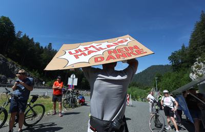 27 June 2026, Austria, Reutte: During a rally on the blocked B179 Fernpass Road, a protester holds up a sign that reads "Ulm-Milan, No Thanks." Photo: Karl-Josef Hildenbrand/dpa (Photo by Karl-Josef Hildenbrand/picture alliance via Getty Images)