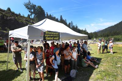 27 June 2026, Austria, Reutte: Protesters stand under a sunshade during a rally next to the closed B179 Fernpass Road. Photo: Karl-Josef Hildenbrand/dpa (Photo by Karl-Josef Hildenbrand/picture alliance via Getty Images)