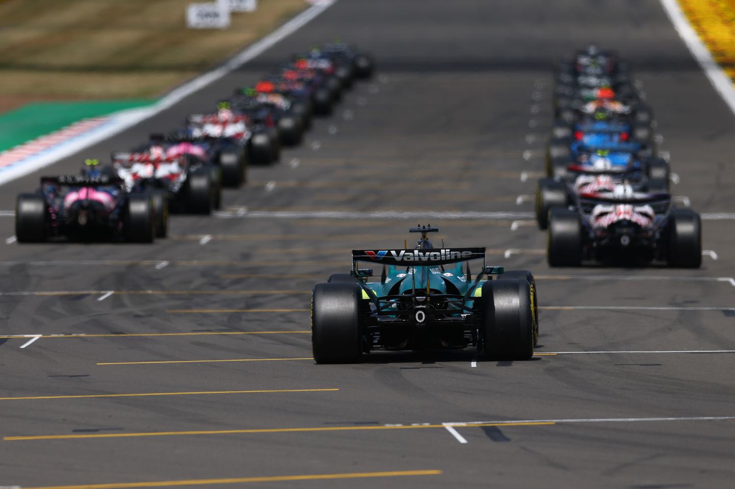 NORTHAMPTON, ENGLAND - JULY 05: Lance Stroll of Canada driving the (18) Aston Martin F1 Team AMR26 Honda takes his grid spot ready for the start during the F1 Grand Prix of Great Britain at Silverstone Circuit on July 05, 2026 in Northampton, England. (Photo by Bryn Lennon - Formula 1/Formula 1 via Getty Images)