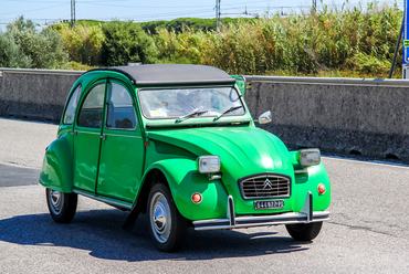 Tuscany, Itlay - August 1, 2014: Motor car Citroen 2CV drives at the interurban freeway.