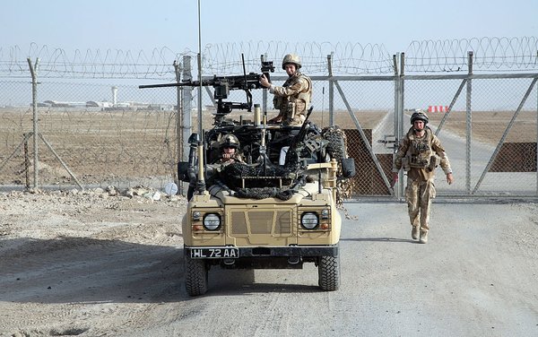 BASRA, IRAQ - OCTOBER 18: A RAF serviceman walks to his Land Rover after closing the gate to Basra Airbase while on route to the village of Al Houta on October 18 2008 near Basra, Iraq. The trip by the 51 Sqn Royal Air Force Regiment Force Protection Wing was part of a 'key leader engagement' (KLE) visit to the village close to the Basra Airbase to recruit local labour and engage with the village sheikh. Visits of this type are seen as key in efforts to continue winning the support of the local Iraqi population. Although improved security in the region has brought some benefits such as improved trade and commerce, much of the infrastructure remains in a poor state of repair. Britain's Prime Minister Gordon Brown has indicated that the number of UK troops could be scaled down - especially as the security situation in the south of the country continues to improve.  (Photo by Matt Cardy/Getty Images)