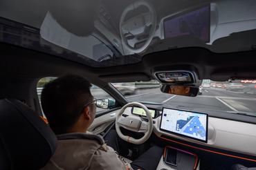 CHONGQING, CHINA - DECEMBER 24: A Changan Automobile vehicle with a Level 3 autonomous driving license plate drives on the road on December 24, 2025 in Chongqing, China. China's first official license plate dedicated to Level-3 (L3) autonomous driving, "Yu-AD0001Z," was issued by authorities in Southwest China's Chongqing city. The license plate was granted by Chongqing's public security and traffic authority to Changan Automobile Co. Changan Automobile wins China's first license plate for Level 3 autonomous driving after 5 million kilometers of testing. (Photo by He Penglei/China News Service/VCG via Getty Images)