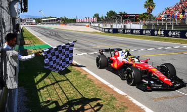 BARCELONA, SPAIN - JUNE 14: Race winner Lewis Hamilton of Great Britain driving the (44) Scuderia Ferrari SF-26 crosses the line as Novak Djokovic waves the chequered flag during the F1 Grand Prix of Barcelona-Catalunya at Circuit de Barcelona-Catalunya on June 14, 2026 in Barcelona, Spain. (Photo by Mark Sutton - Formula 1/Formula 1 via Getty Images)